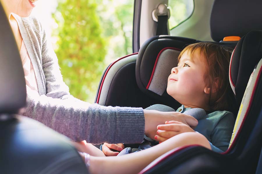Blog - Young Toddler Girl Being Placed in Her Car Seat